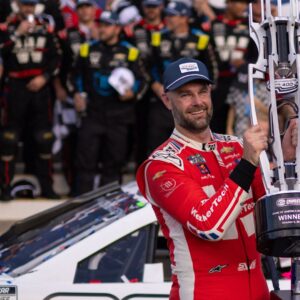 Oct 5, 2025; Concord, North Carolina, USA; NASCAR Cup Series driver Shane van Gisbergen (88) raises the Roval trophy in victory lane at Charlotte Motor Speedway Road Course.