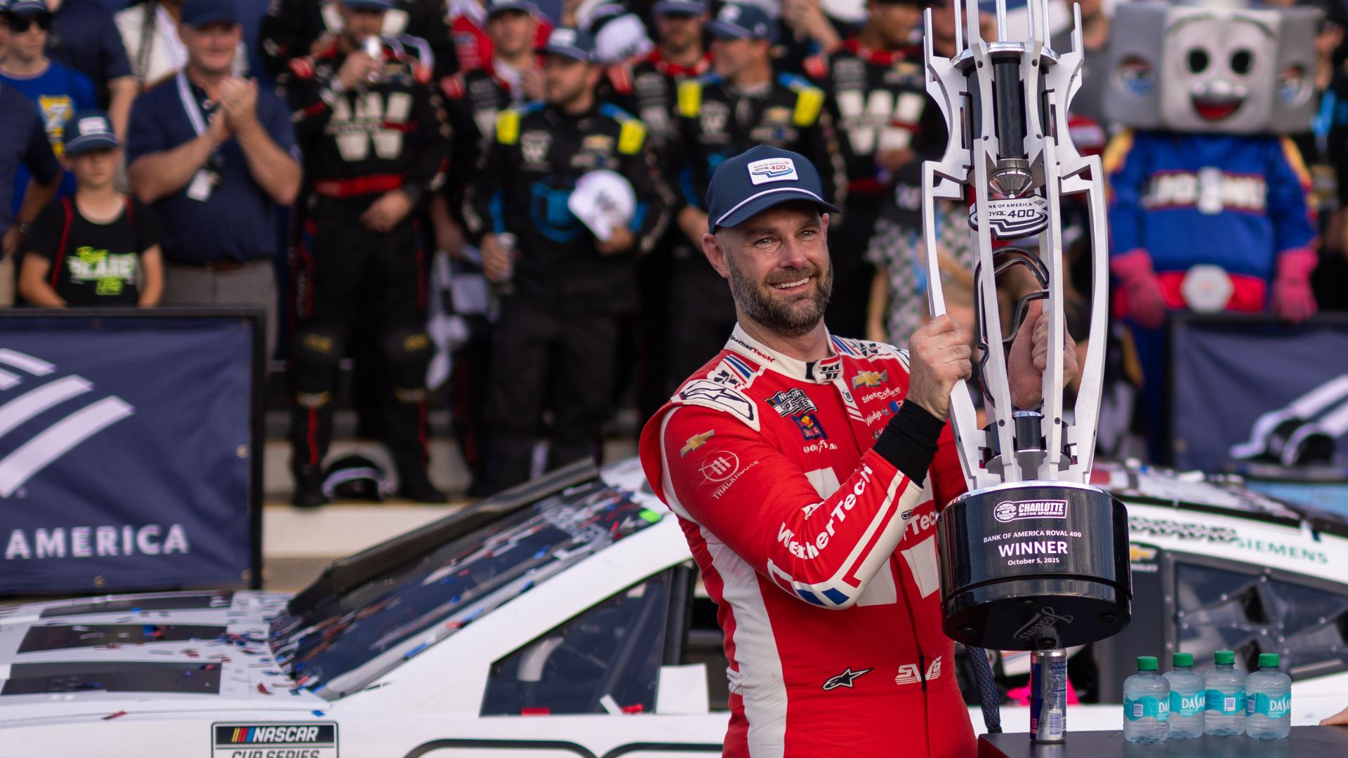 Oct 5, 2025; Concord, North Carolina, USA; NASCAR Cup Series driver Shane van Gisbergen (88) raises the Roval trophy in victory lane at Charlotte Motor Speedway Road Course.