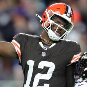 Cleveland Browns quarterback Shedeur Sanders (12) is hit by Baltimore Ravens linebacker Trenton Simpson (32) during the second half of an NFL football game at Huntington Bank Field, Nov. 16, 2025, in Cleveland, Ohio.