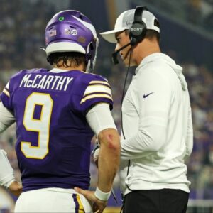 Minnesota Vikings quarterback J.J. McCarthy (9) speaks with Minnesota Vikings head coach Kevin O'Connell during the first half against the Atlanta Falcons at U.S. Bank Stadium.