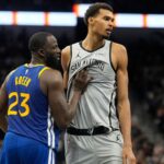San Antonio Spurs forward Victor Wembanyama (1) waits for an inbound pass while defended by Golden State Warriors forward Draymond Green (23) during the second half at Frost Bank Center.