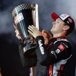 Oct 31, 2025; Avondale, Arizona, USA; NASCAR Gander RV and Outdoors Truck Series driver Corey Heim (11) celebrates his victory following the Truck Series Championship race at Phoenix Raceway
