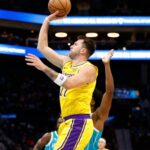 Nov 10, 2025; Charlotte, North Carolina, USA; Los Angeles Lakers forward/guard Luka Doncic (77) floats a shot towards the basket during the first quarter against the Charlotte Hornets at Spectrum Center.