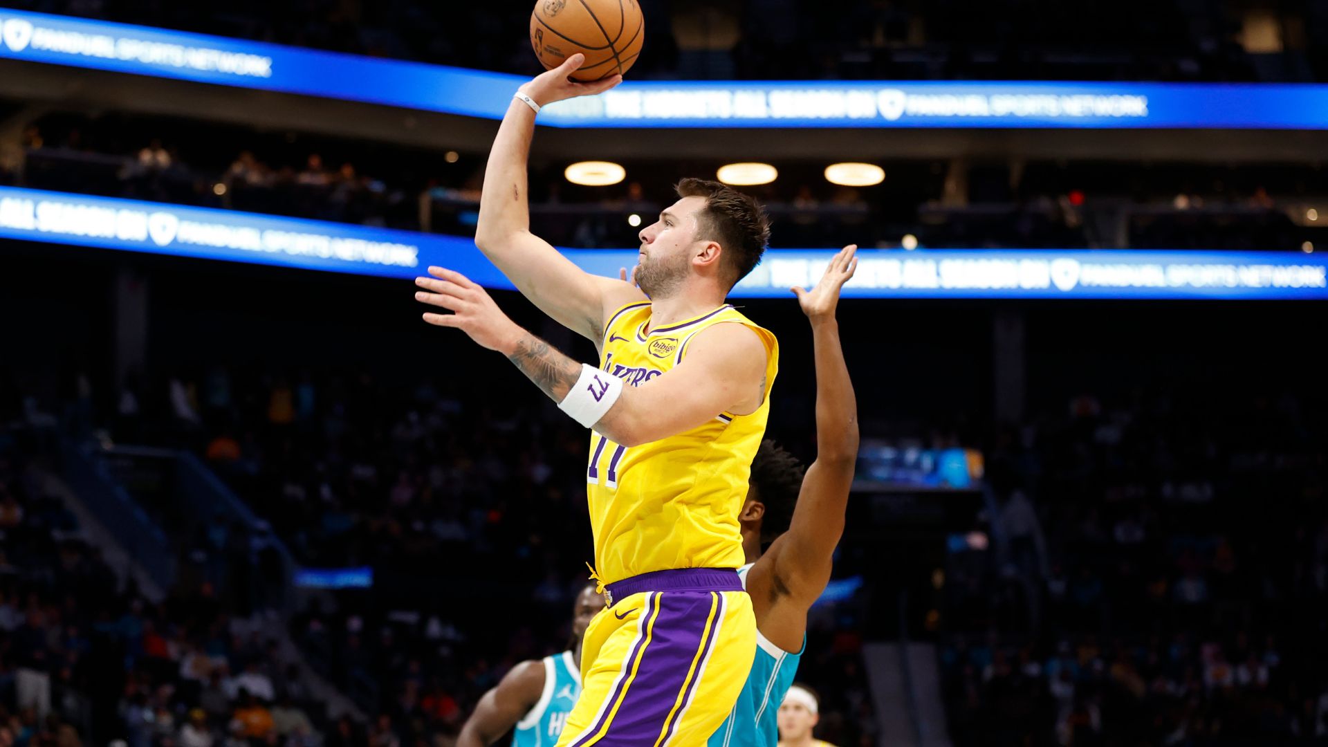 Nov 10, 2025; Charlotte, North Carolina, USA; Los Angeles Lakers forward/guard Luka Doncic (77) floats a shot towards the basket during the first quarter against the Charlotte Hornets at Spectrum Center.