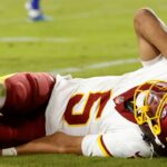 Washington Commanders quarterback Jayden Daniels (5) reacts to an injury during the second half against the Washington Commanders at Northwest Stadium.