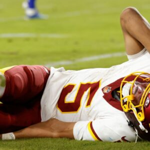 Washington Commanders quarterback Jayden Daniels (5) reacts to an injury during the second half against the Washington Commanders at Northwest Stadium.