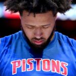 Nov 5, 2025; Detroit, Michigan, USA; Detroit Pistons guard Cade Cunningham (2) stands at attention during the National Anthem before their game against the Utah Jazz at Little Caesars Arena.