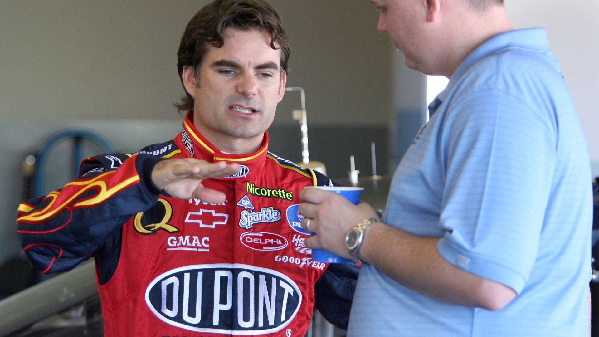 Jeff Gordon, left, driver of the No. 24 DuPont Chevrolet, talks to his crew chief Steve Letarte in the garage during NASCAR, Motorsport, USA preseason testing at the Daytona International Speedway in Daytona Beach, Florida