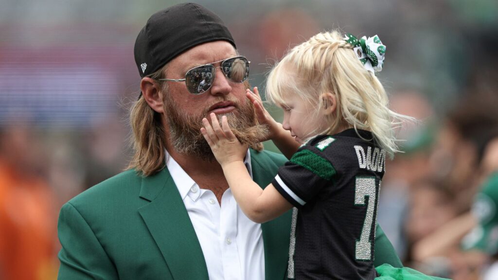 Retired New York Jets center Nick Mangold with his daughter before the game against the Cincinnati Bengals at MetLife Stadium.