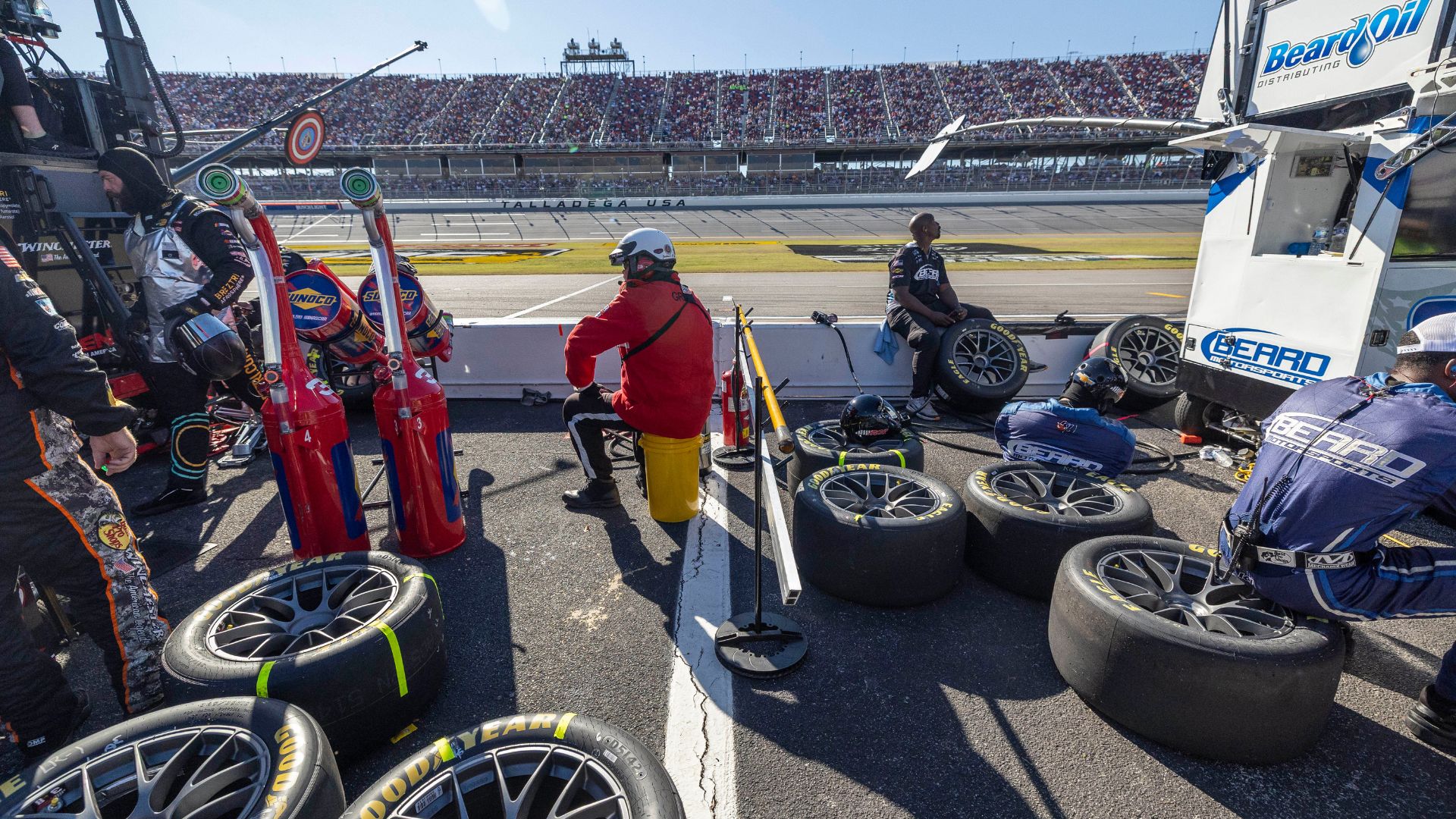 Oct 19, 2025; Talladega, Alabama, USA; Pit crews wait for their drivers during stage two of the YellaWood 500 at Talladega Superspeedway
