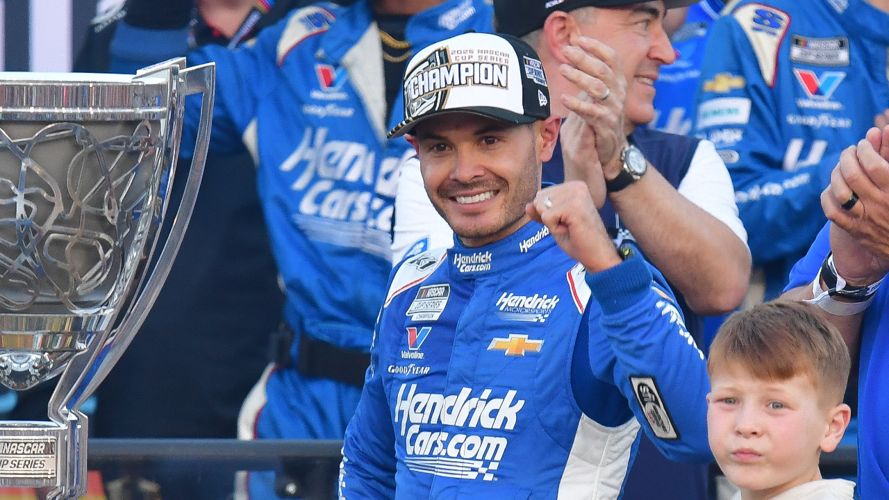 Nov 2, 2025; Avondale, Arizona, USA; NASCAR Cup Series driver Kyle Larson (5) celebrates his championship victory following the Cup Series Championship race with son Owen at Phoenix Raceway. Mandatory Credit: Gary A. Vasquez-Imagn Images