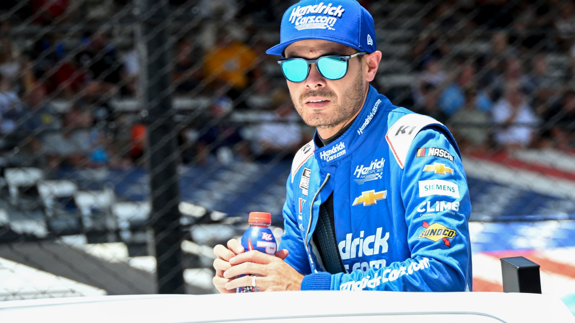 NASCAR Cup Series driver Kyle Larson (5) rides in a truck Sunday, July 27, 2025, ahead of the Brickyard 400 at Indianapolis Motor Speedway.