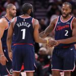 Dec 11, 2025; Houston, Texas, USA; Los Angeles Clippers forward Kawhi Leonard (2) reacts with guard James Harden (1) and forward Nicolas Batum (33) after a play during the fourth quarter against the Houston Rockets at Toyota Center.