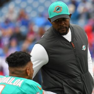 Miami Dolphins head coach Brian Flores greets quarterback Tua Tagovailoa (1) prior to the game against the Buffalo Bills at Highmark Stadium.
