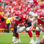 Kansas City Chiefs offensive tackle Jawaan Taylor (74) and guard Trey Smith (65) and center Creed Humphrey (52) at the line of scrimmage against the Philadelphia Eagles during the game at GEHA Field at Arrowhead Stadium.