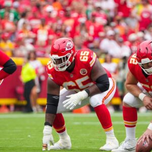 Kansas City Chiefs offensive tackle Jawaan Taylor (74) and guard Trey Smith (65) and center Creed Humphrey (52) at the line of scrimmage against the Philadelphia Eagles during the game at GEHA Field at Arrowhead Stadium.