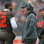 Cleveland Browns quarterback Shedeur Sanders (12) talks with coach Kevin Stefanski during a game against the Tennessee Titans on Dec. 7, 2025, in Cleveland.