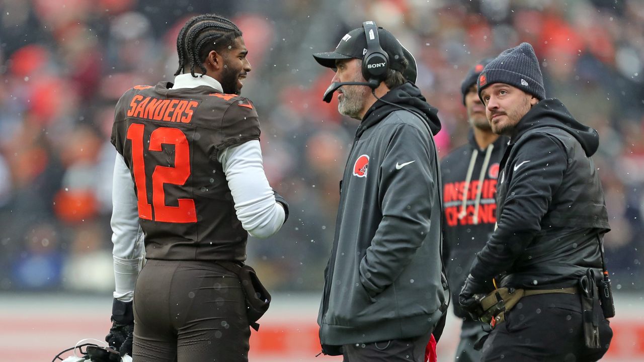 Cleveland Browns quarterback Shedeur Sanders (12) talks with coach Kevin Stefanski during a game against the Tennessee Titans on Dec. 7, 2025, in Cleveland.