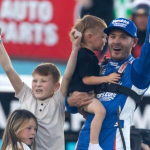 Nov 2, 2025; Avondale, Arizona, USA; NASCAR Cup Series driver Kyle Larson (5) celebrates with children Owen Larson, Audrey Larson and Cooper Larson after clinching the 2025 NASCAR Cup Series Championship following the NASCAR Championship race at Phoenix Raceway