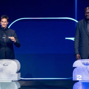 Former National Football League (NFL) Quarterback and seven-time Super Bowl champion Tom Brady draws Spain as Four-time National Basketball Association (NBA) championship winner and Hall of Famer Shaquille O Neal looks on