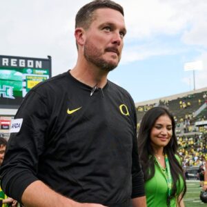 Oregon Ducks head coach Dan Lanning walks off the field with his wife, Sauphia, after a game against the Portland State Vikings at Autzen Stadium.