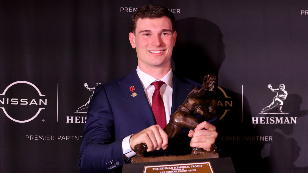 Indiana Hoosiers quarterback Fernando Mendoza poses for photos with the Heisman trophy during a press conference at the New York Marriott Marquis after winning the award.