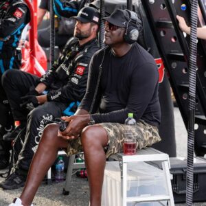 Apr 6, 2025; Darlington, South Carolina, USA; NASCAR Cup Series driver Tyler Reddick (45) team owner Michael Jordan watches his racer during the Goodyear 400 at Darlington Raceway.