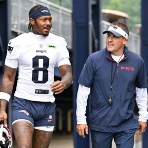 New England Patriots wide receiver Stefon Diggs (8) and offensive coordinator Josh McDaniels walk to the practice fields at Gillette Stadium.