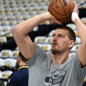 Dec 20, 2025; Denver, Colorado, USA; Denver Nuggets center Nikola Jokic (15) warms up before the game against the Houston Rockets at Ball Arena.