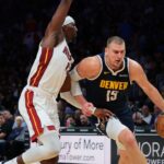 Denver Nuggets center Nikola Jokic (15) drives to the basket against Miami Heat center Bam Adebayo (13) during the second quarter at Kaseya Center.