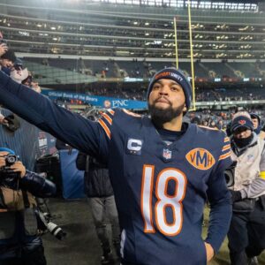 Chicago Bears quarterback Caleb Williams (18) high fives fans after defeating the Green Bay Packers during overtime at Soldier Field.