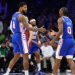 Philadelphia 76ers forward Paul George (8) reacts with guard Tyrese Maxey (0) against the Miami Heat in the first quarter at Wells Fargo Center.