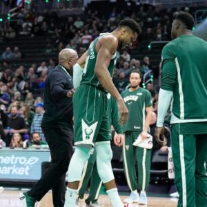 Dec 3, 2025; Milwaukee, Wisconsin, USA; Milwaukee Bucks forward Giannis Antetokounmpo (34) grimaces as he limps off the court after going down with an injury in the first half against the Detroit Pistons at Fiserv Forum. Mandatory Credit: Michael McLoone-Imagn Images