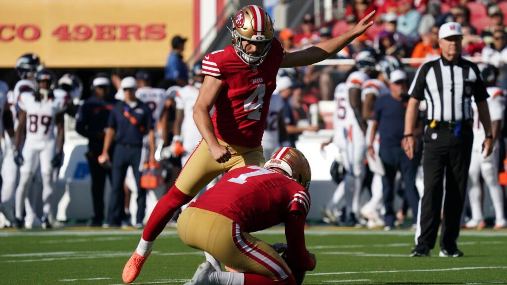 San Francisco 49ers kicker Jake Moody (4) kicks an extra point as punter Thomas Morstead (7) holds the ball in the first quarter against the Denver Broncos at Levi's Stadium