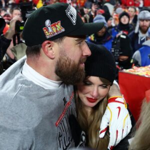Recording artist Taylor Swift and Kansas City Chiefs tight end Travis Kelce (87) react after the AFC Championship game against the Buffalo Bills at GEHA Field at Arrowhead Stadium.