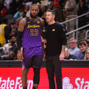 Dec 6, 2024; Atlanta, Georgia, USA; Los Angeles Lakers forward LeBron James (23) talks to head coach JJ Redick against the Atlanta Hawks in the second quarter at State Farm Arena