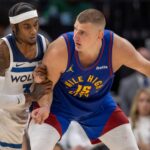 May 10, 2024; Minneapolis, Minnesota, USA; Denver Nuggets center Nikola Jokic (15) controls the ball as Minnesota Timberwolves forward Jaden McDaniels (3) defends in the second half during game three of the second round for the 2024 NBA playoffs at Target Center.