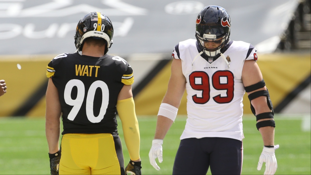 NFL referee Shawn Smith (14) flips the coin as brothers Pittsburgh Steelers outside linebacker T.J. Watt (90) and Houston Texans defensive end J.J. Watt (99) take part before their game against at Heinz Field. The Steelers won 28-21.