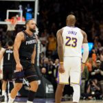 Dec 14, 2025; Phoenix, Arizona, USA; Phoenix Suns forward Dillon Brooks (3) and Los Angeles Lakers forward LeBron James (23) react during an altercation that resulted in a technical for Brooks during the second half of a game at at Mortgage Matchup Center.