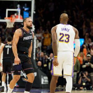 Dec 14, 2025; Phoenix, Arizona, USA; Phoenix Suns forward Dillon Brooks (3) and Los Angeles Lakers forward LeBron James (23) react during an altercation that resulted in a technical for Brooks during the second half of a game at at Mortgage Matchup Center.