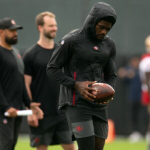 Still recovering from knee surgery, San Francisco 49ers wide receiver Brandon Aiyuk (left) hangs out with teammate George Kittle (85) during the second day of training camp.