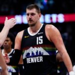 Denver Nuggets center Nikola Jokic (15) comes to the bench in overtime against the Minnesota Timberwolves at Ball Arena.