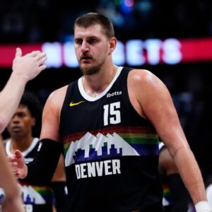 Denver Nuggets center Nikola Jokic (15) comes to the bench in overtime against the Minnesota Timberwolves at Ball Arena.