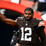 Cleveland Browns quarterback Shedeur Sanders (12) runs on the field before the game against the San Francisco 49ers at Huntington Bank Field.