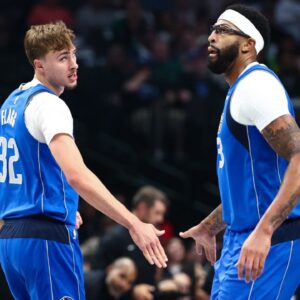 Dallas Mavericks forward Cooper Flagg (32) celebrates with Dallas Mavericks forward Anthony Davis (3) during the first quarter against the Washington Wizards at American Airlines Center.