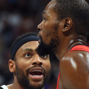 Dec 20, 2025; Denver, Colorado, USA; Denver Nuggets guard Bruce Brown (11) talks with Houston Rockets forward Kevin Durant (7) after a defensive stop during the second half at Ball Arena.
