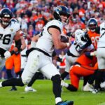 Jacksonville Jaguars quarterback Trevor Lawrence (16) rushes for a touchdown against the Denver Broncos during the second half at Empower Field at Mile High.