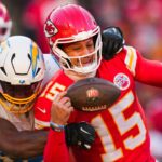 Los Angeles Chargers linebacker Odafe Oweh (98) sacks Kansas City Chiefs quarterback Patrick Mahomes (15) during the second half at GEHA Field at Arrowhead Stadium.