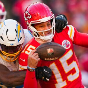 Los Angeles Chargers linebacker Odafe Oweh (98) sacks Kansas City Chiefs quarterback Patrick Mahomes (15) during the second half at GEHA Field at Arrowhead Stadium.