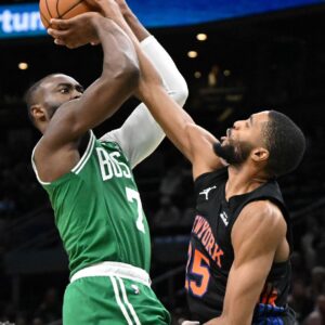 Dec 2, 2025; Boston, Massachusetts, USA; Boston Celtics guard Jaylen Brown (7) attempts a basket past New York Knicks guard Mikal Bridges (25) during the second half at the TD Garden.